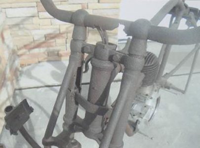 Vintage Motorcycle Frames Stuck in Maple Tree Image